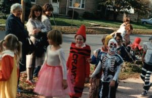 The author with short hair, dressed as a red crayon